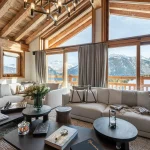 Alpine living room with panoramic mountain views at Chalet Les Bruxellois