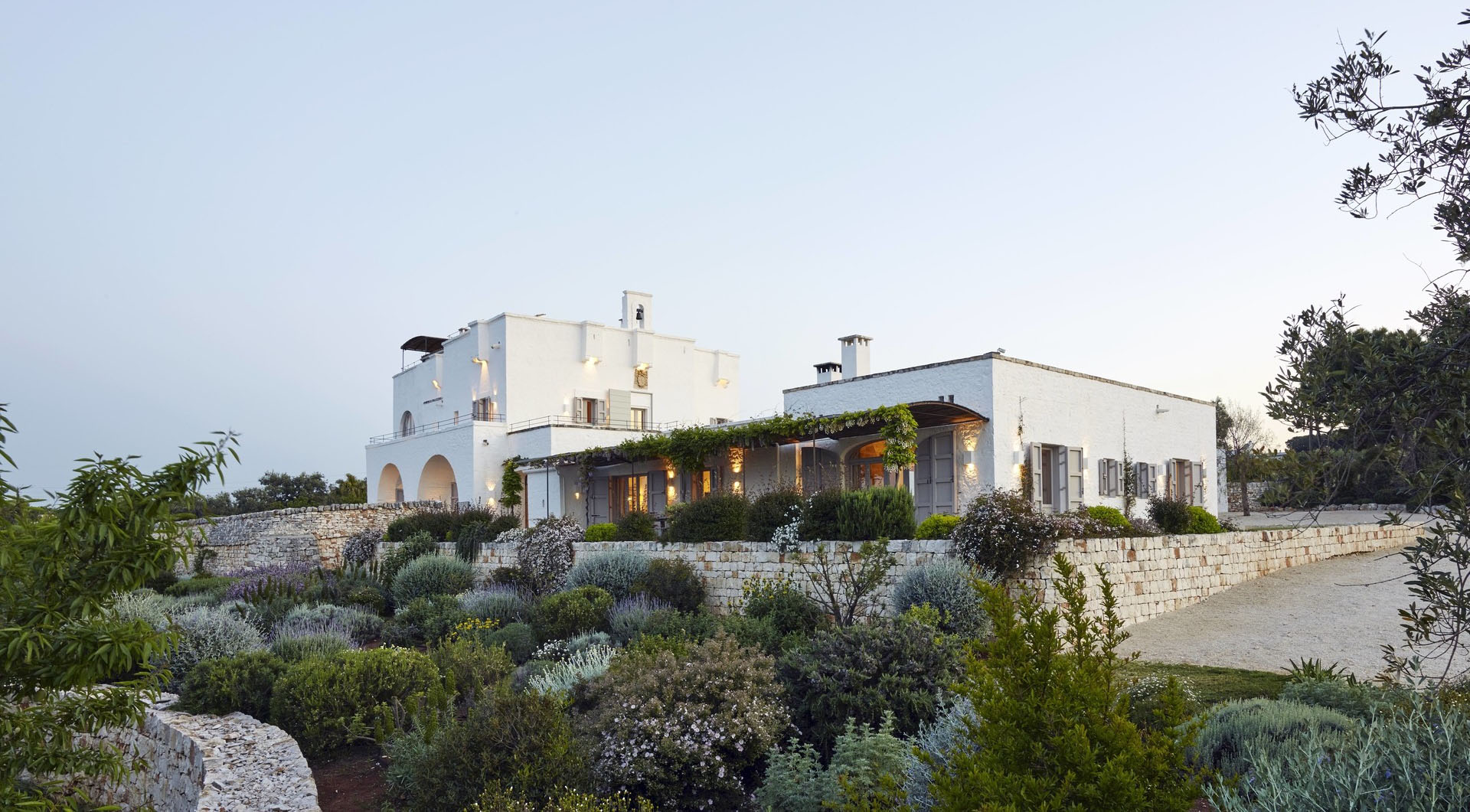 Masseria Petrarolo white farmhouse behind terraced Mediterranean gardens