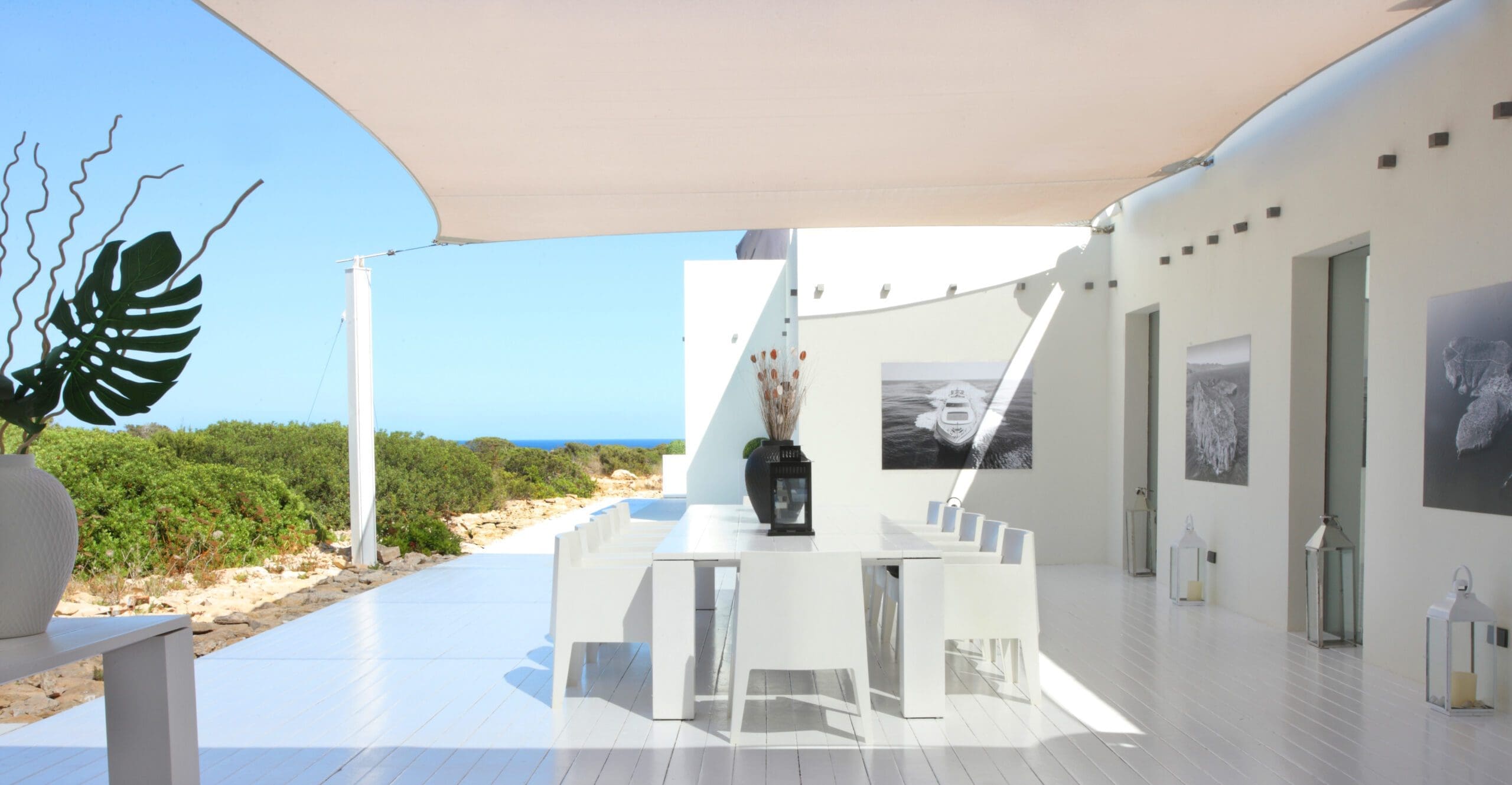 Covered terrace beside the Tagomago villa with a reflective pool and the sea beyond