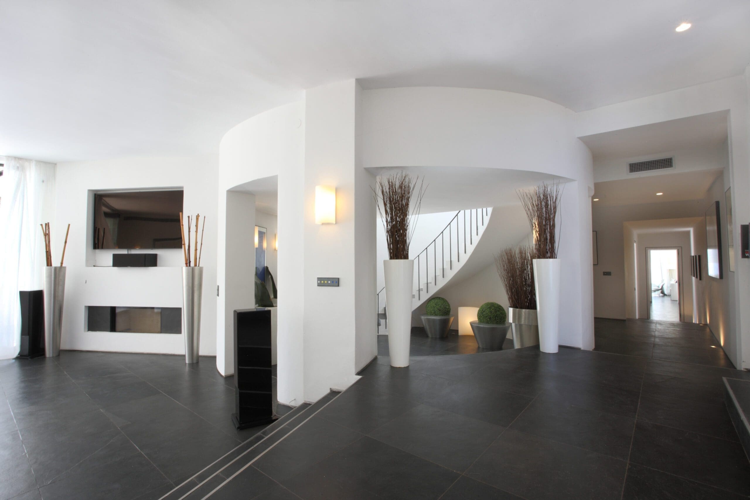 White entrance hall and staircase inside the Tagomago villa