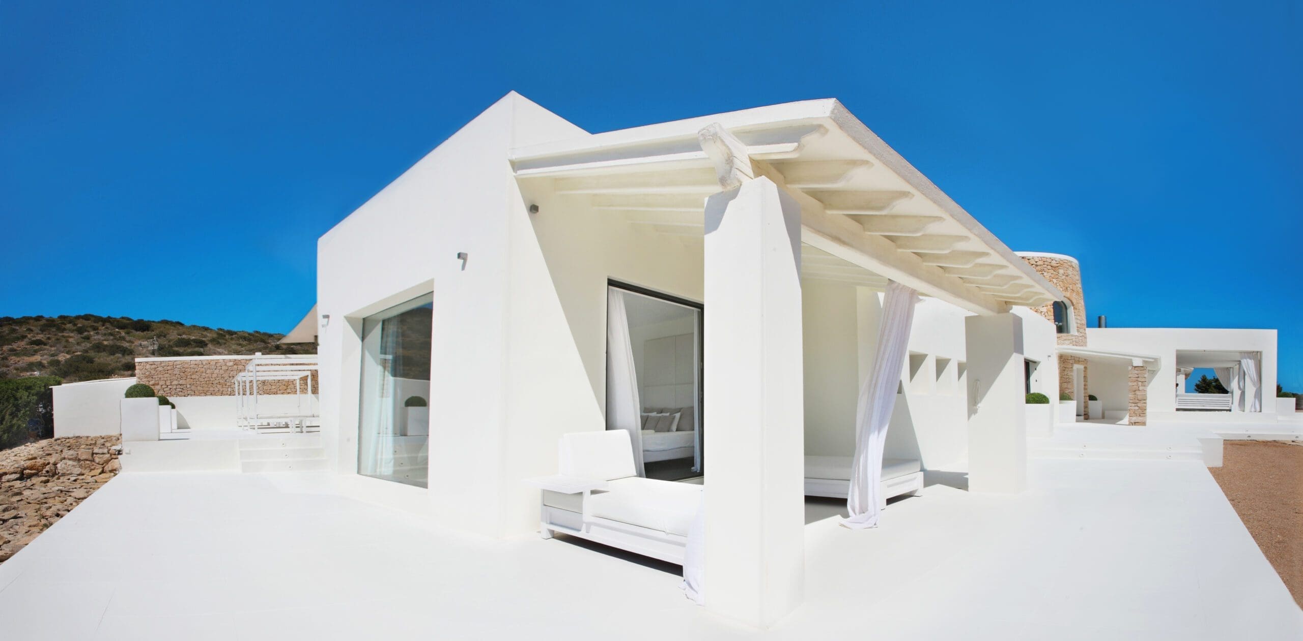 White covered terrace and outdoor seating beside the Tagomago villa