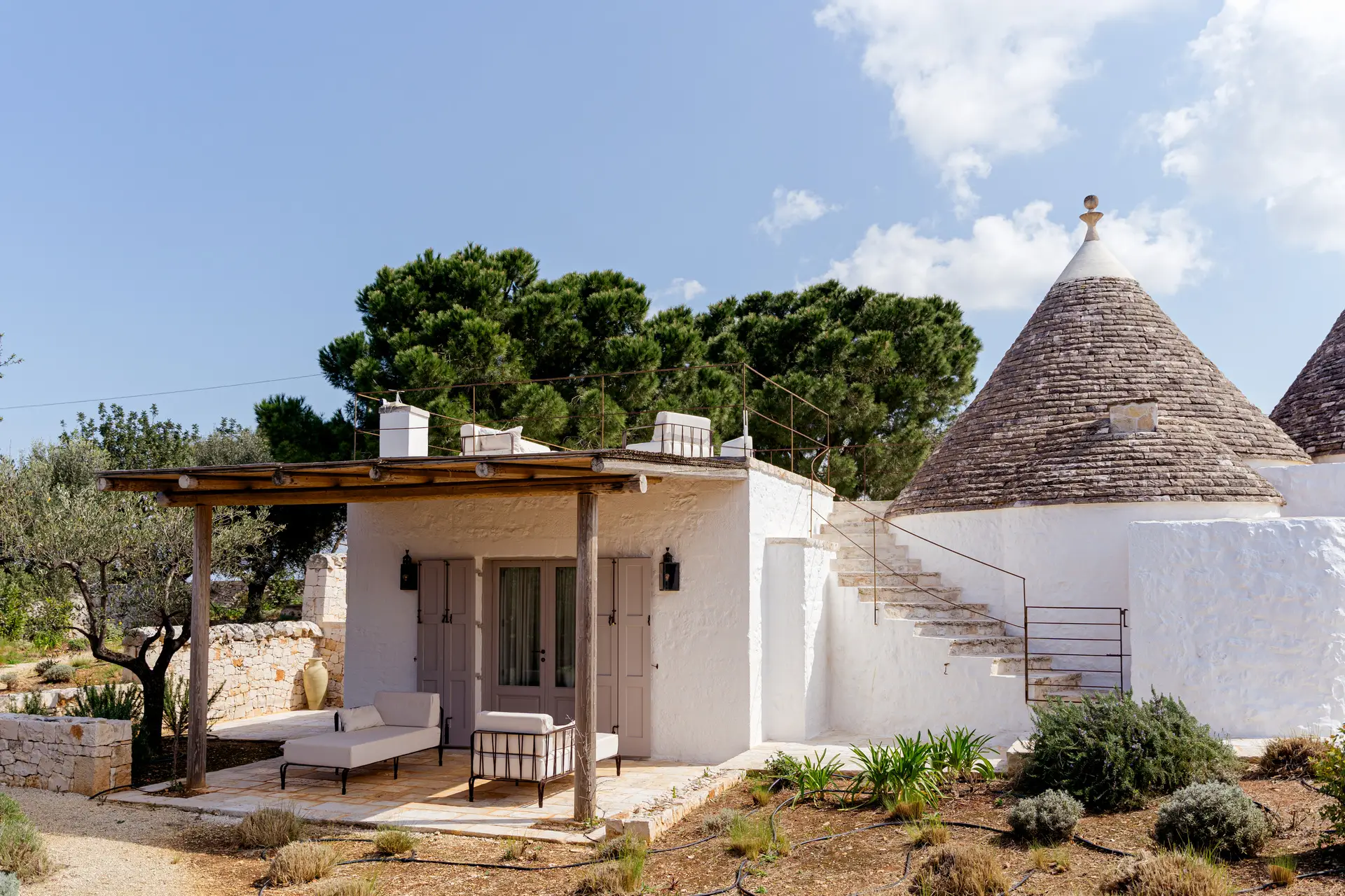 Traditional conical stone roof and shaded terrace at Trullo Petrarolo